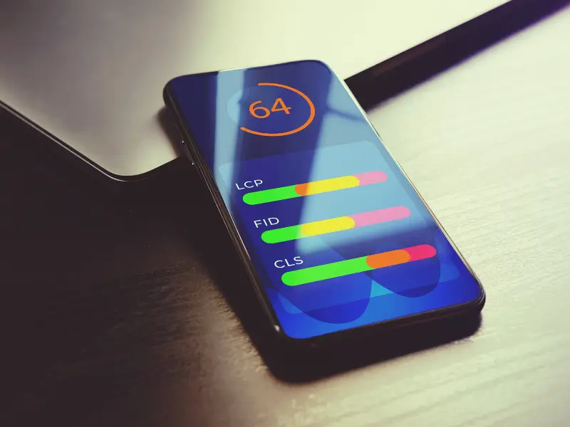 Mobile phone displaying some of the Core Web Vitals metrics such as LCP, FID and CLS.